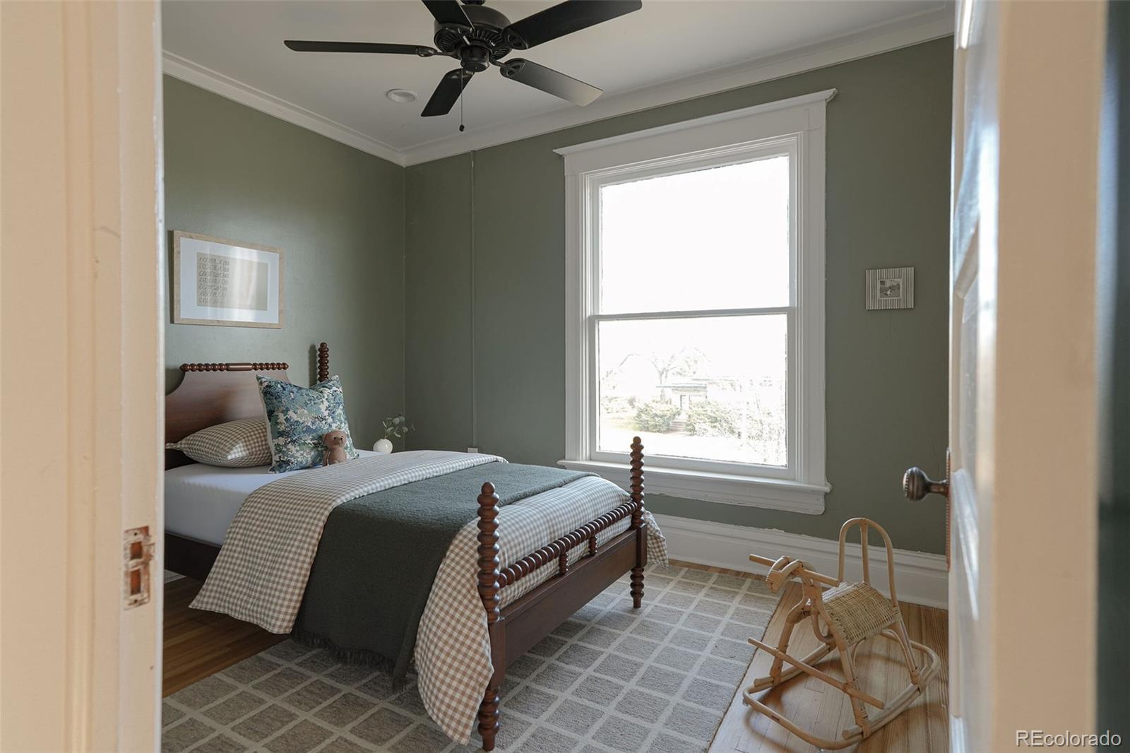 3365 Federal Boulevard Denver, CO 80211 - Photo 31 of 47 a bedroom with a bed and window