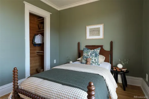 a large bed in a bedroom next to a window