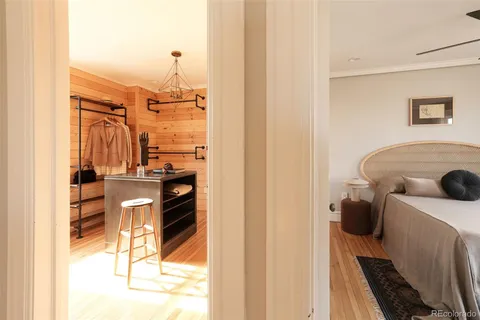 a bedroom with a bed and a painting on the wall