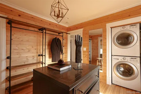 a view of a hallway with furniture and a window