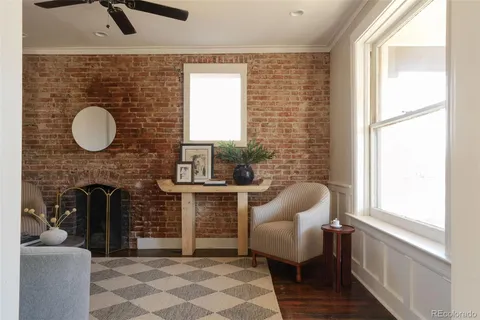 a living room with furniture a window and a fireplace