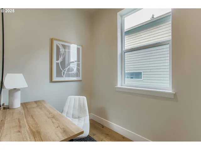a view of bedroom with wooden floor and window
