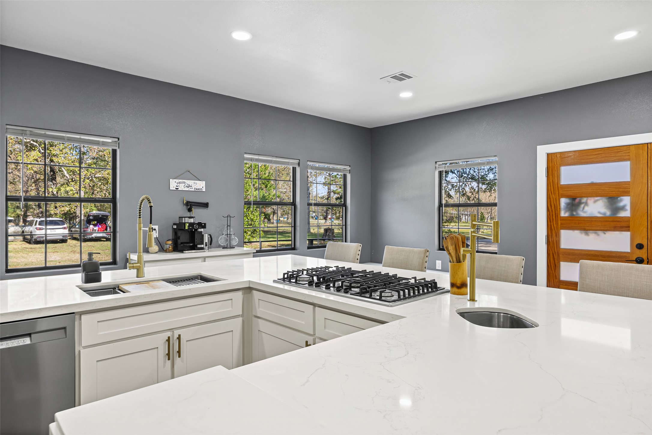 15080 Usher Lane Splendora, TX 77372 - Photo 21 of 44 a kitchen with a sink a stove cabinets and living room