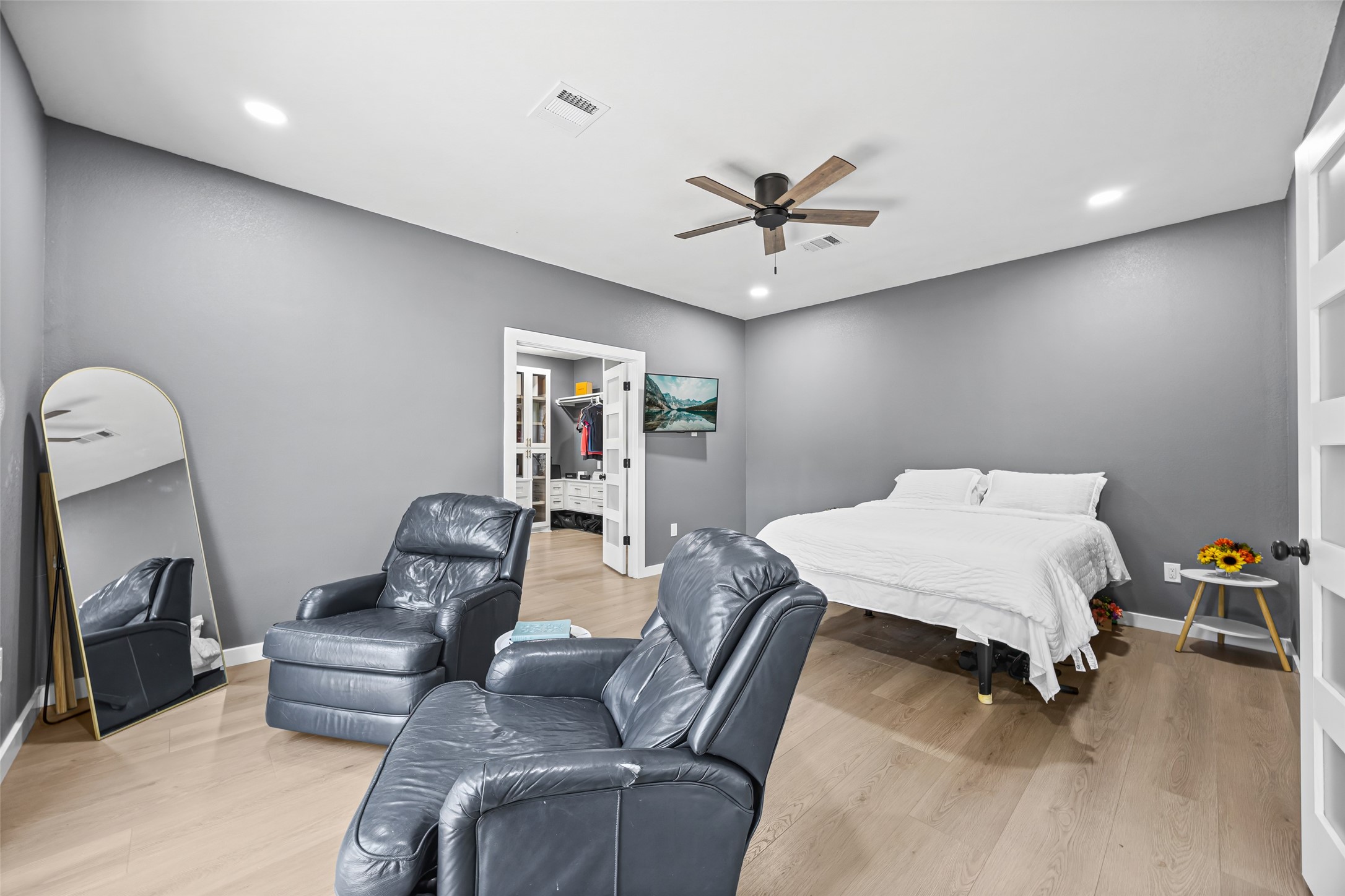 15080 Usher Lane Splendora, TX 77372 - Photo 23 of 44 a bedroom with a bed a couch and a chandelier