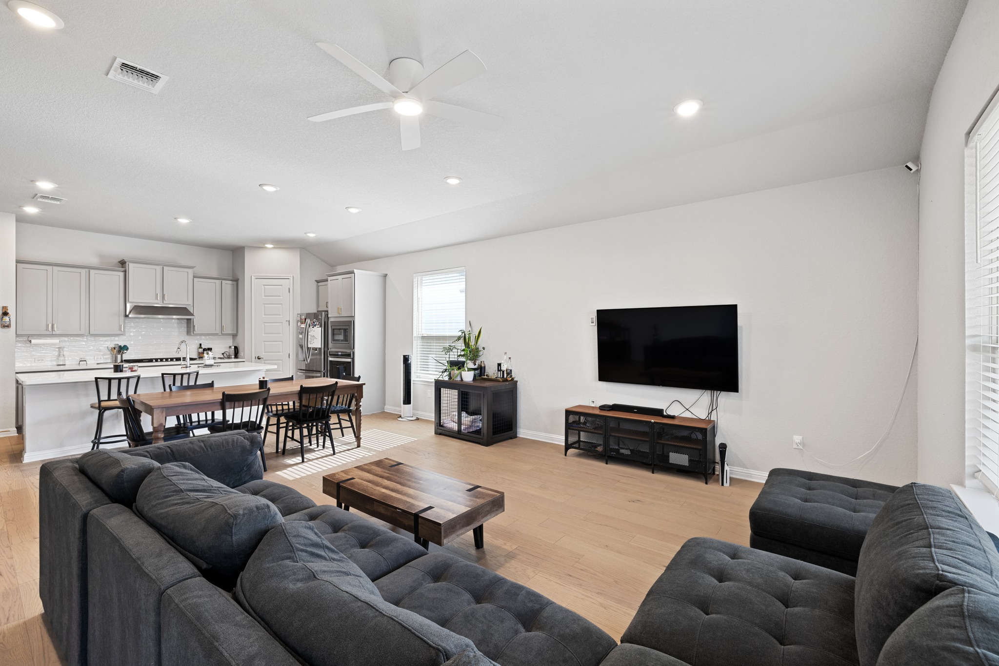 8405 Hubble Walk Austin, TX 78744 - Photo 10 of 36 Living room with a ceiling fan, light wood-style flooring, and recessed lighting