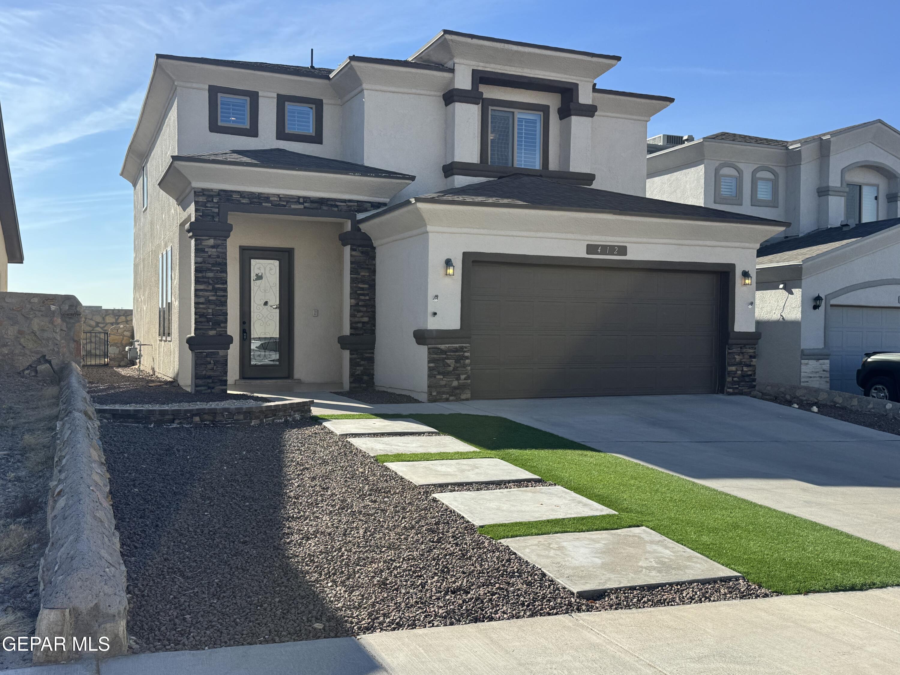 a front view of a house with garden