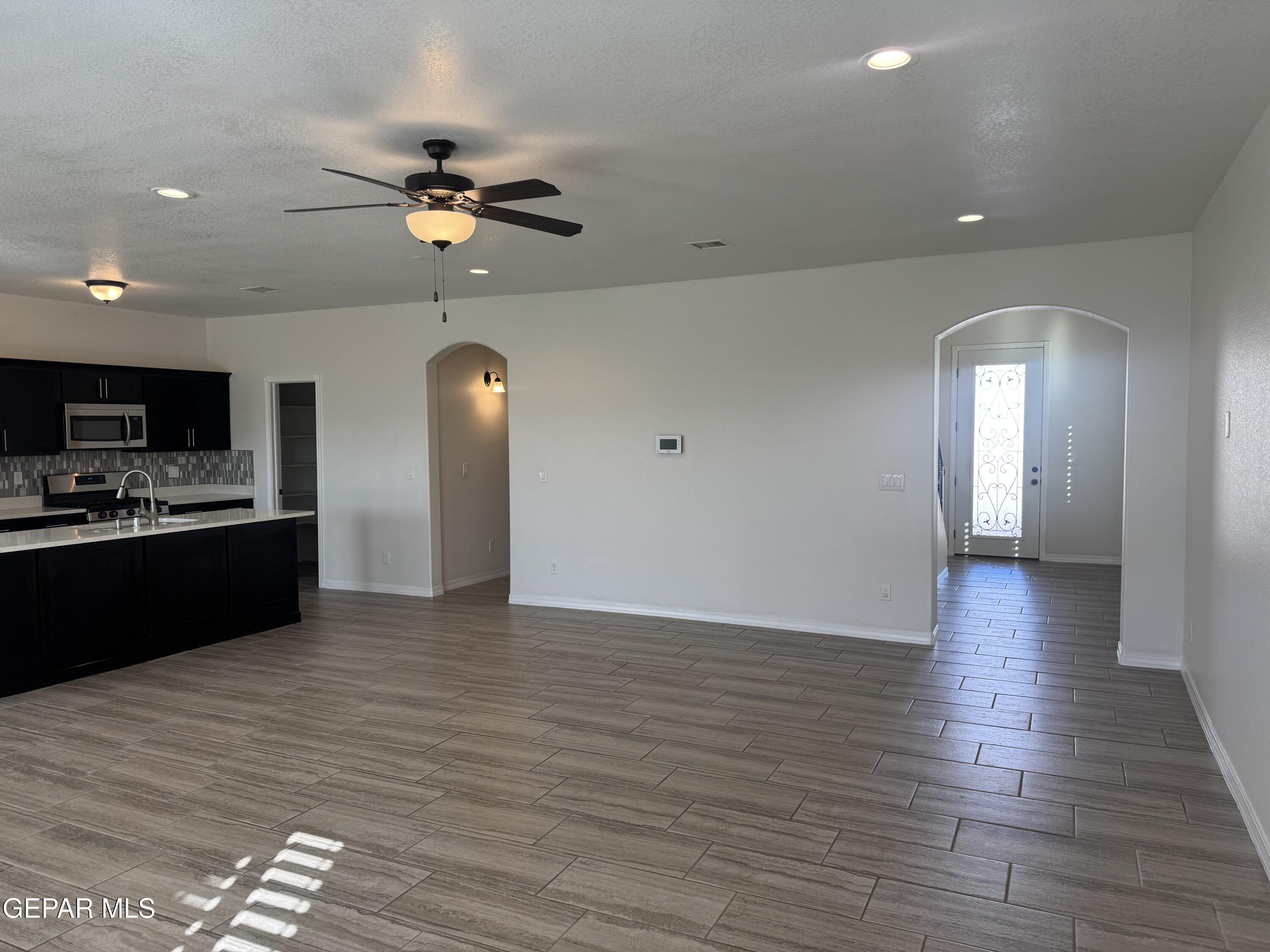 412 Indigo Court El Paso, TX 79932 - Photo 13 of 53 a view of a room with wooden floor and kitchen