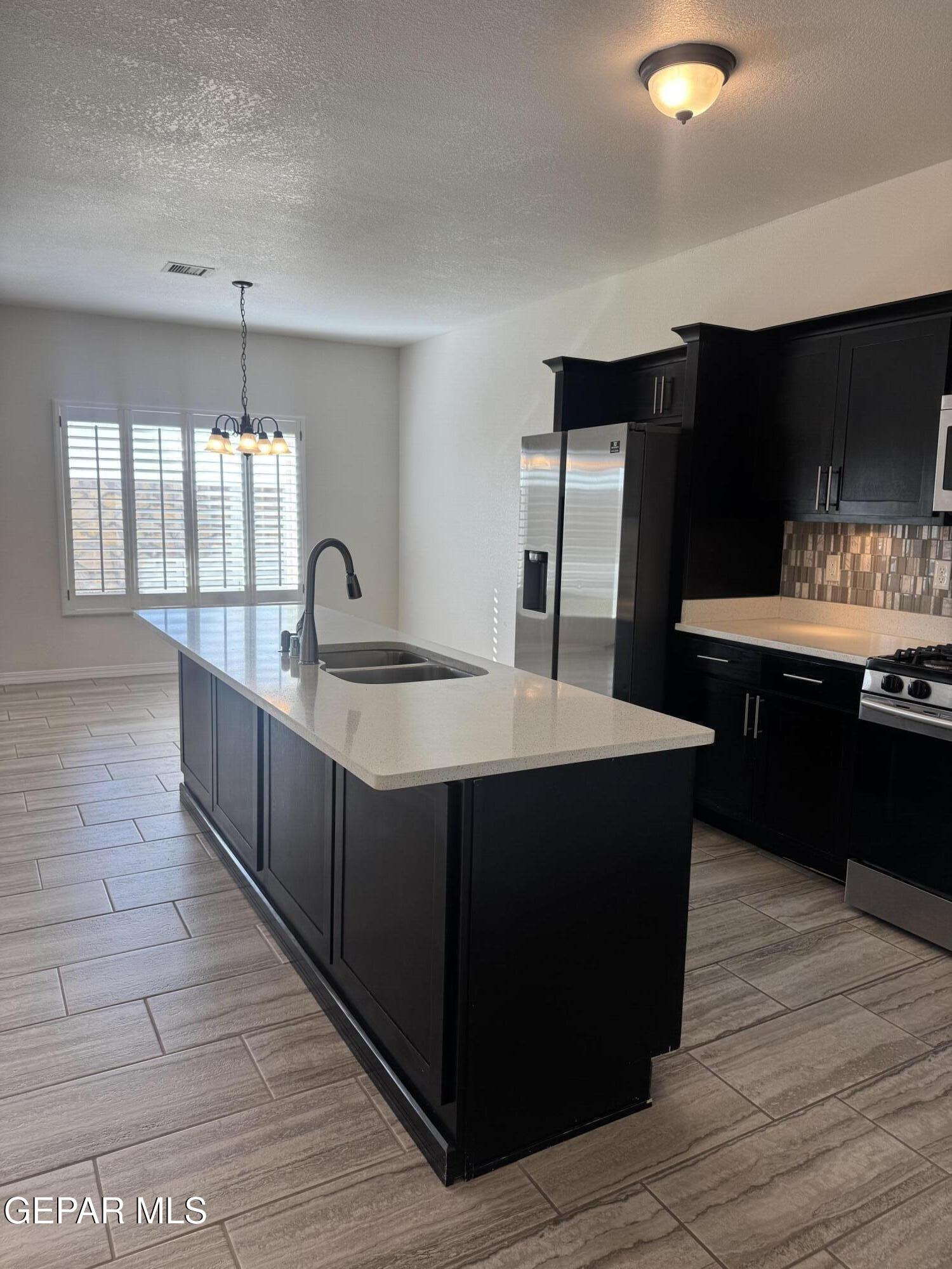 412 Indigo Court El Paso, TX 79932 - Photo 15 of 53 a kitchen with stainless steel appliances granite countertop a sink and a stove