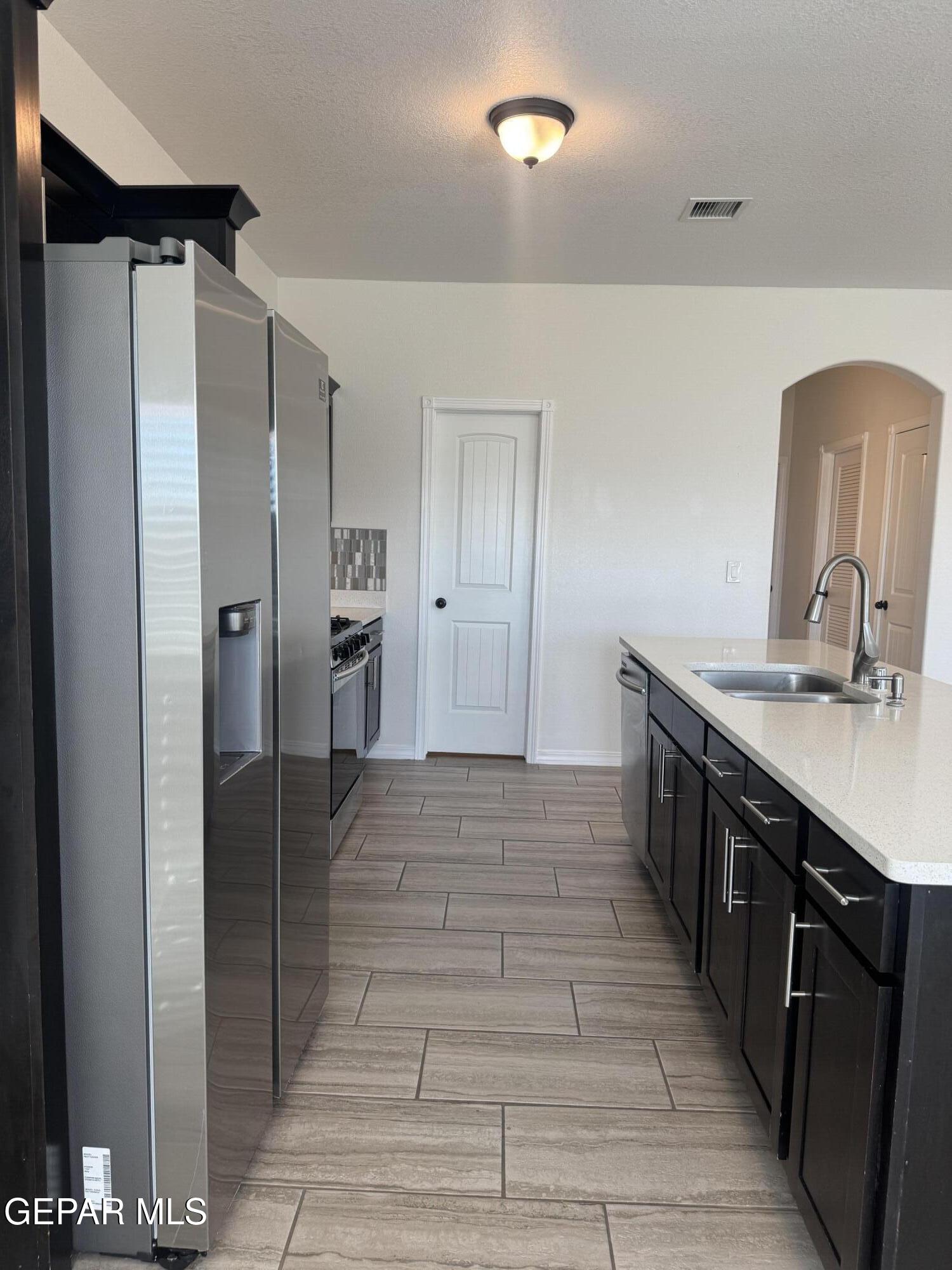 412 Indigo Court El Paso, TX 79932 - Photo 18 of 53 a kitchen with stainless steel appliances granite countertop a refrigerator and a sink