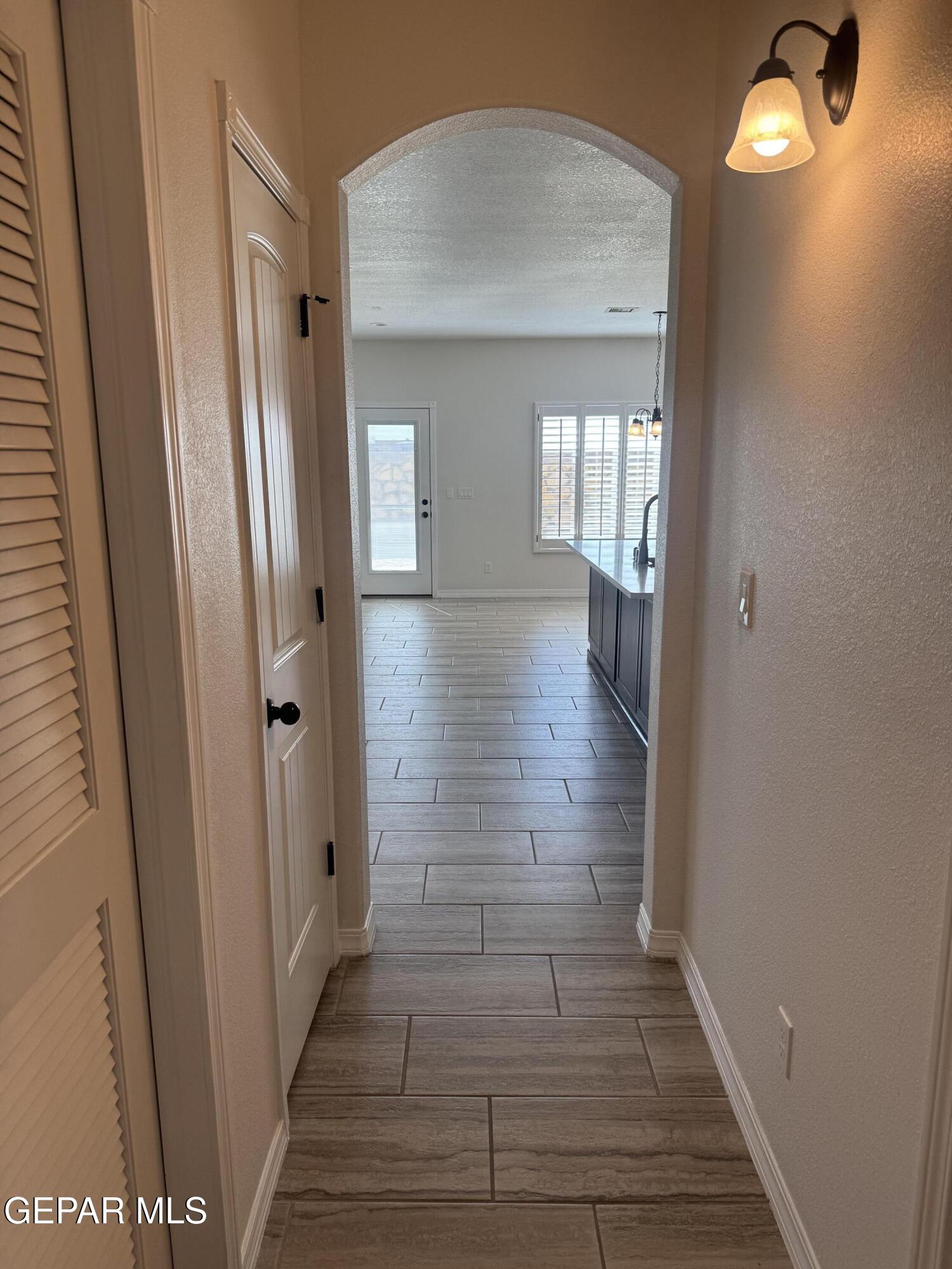 412 Indigo Court El Paso, TX 79932 - Photo 25 of 53 a view of a hallway with wooden floor and staircase