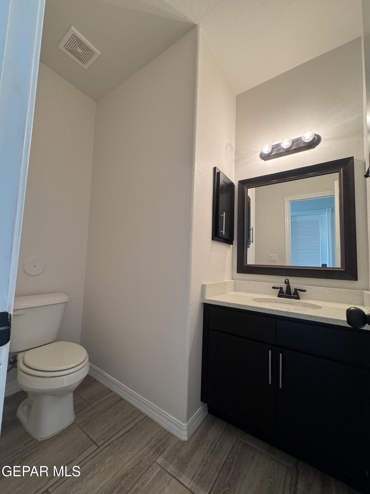412 Indigo Court El Paso, TX 79932 - Photo 26 of 53 a bathroom with a toilet sink and mirror