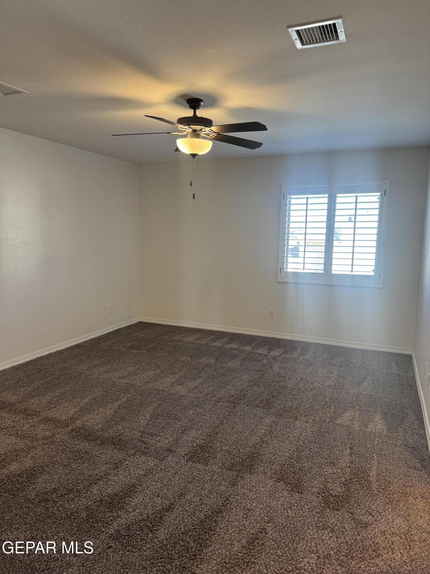 412 Indigo Court El Paso, TX 79932 - Photo 30 of 53 an empty room with windows and chandelier fan