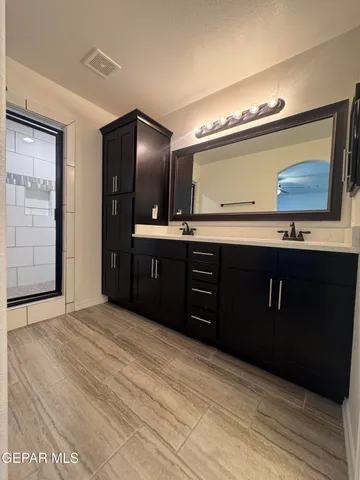 a bathroom with a tub sink and mirror