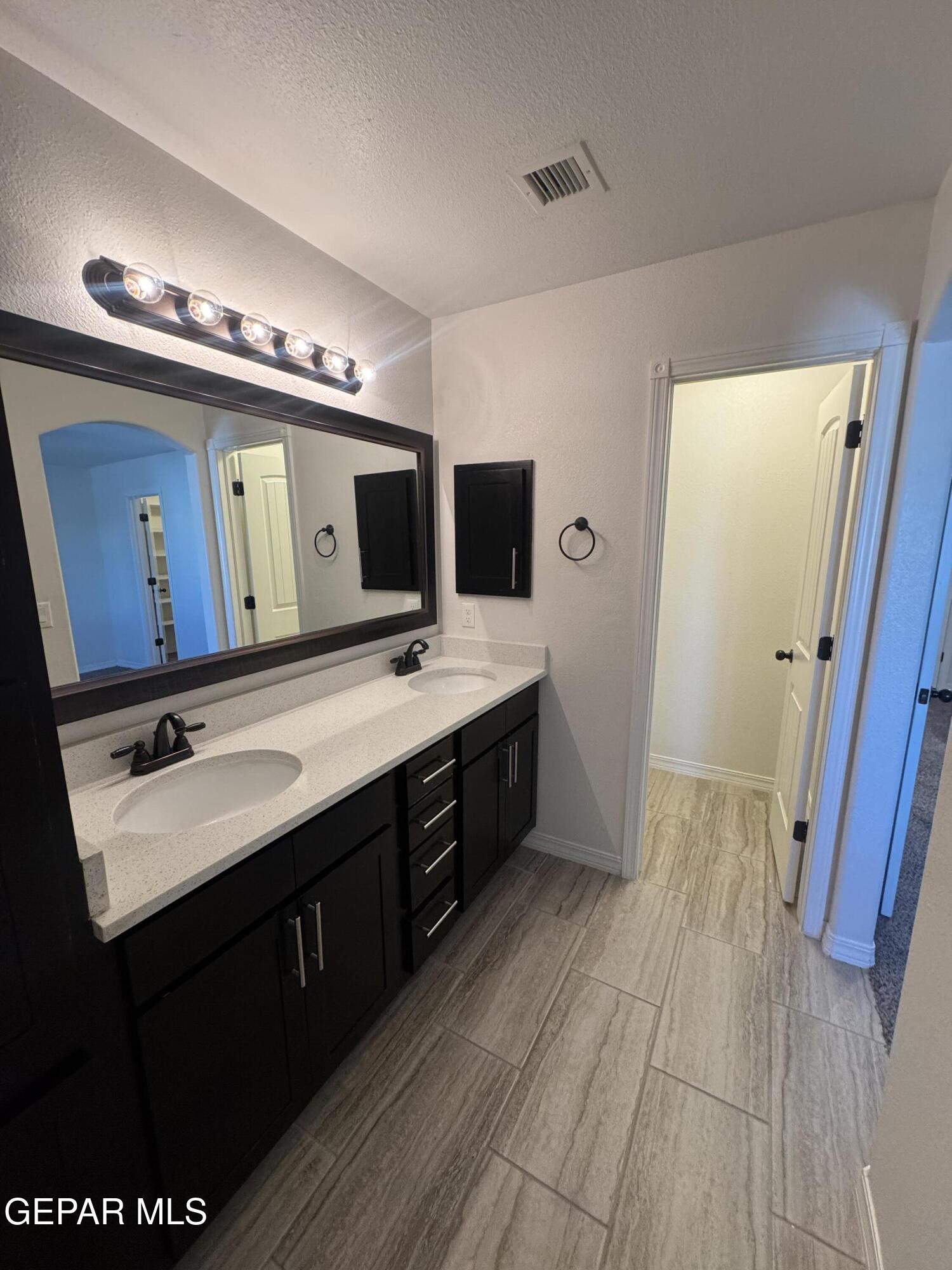 412 Indigo Court El Paso, TX 79932 - Photo 35 of 53 a spacious bathroom with a double vanity sink and a mirror