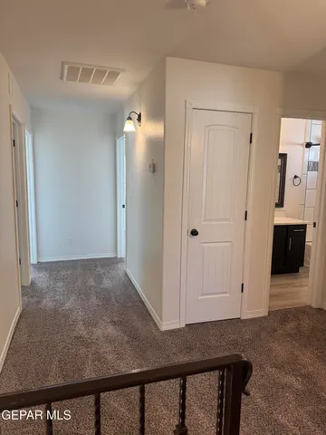 a view of empty room with window and wooden floor