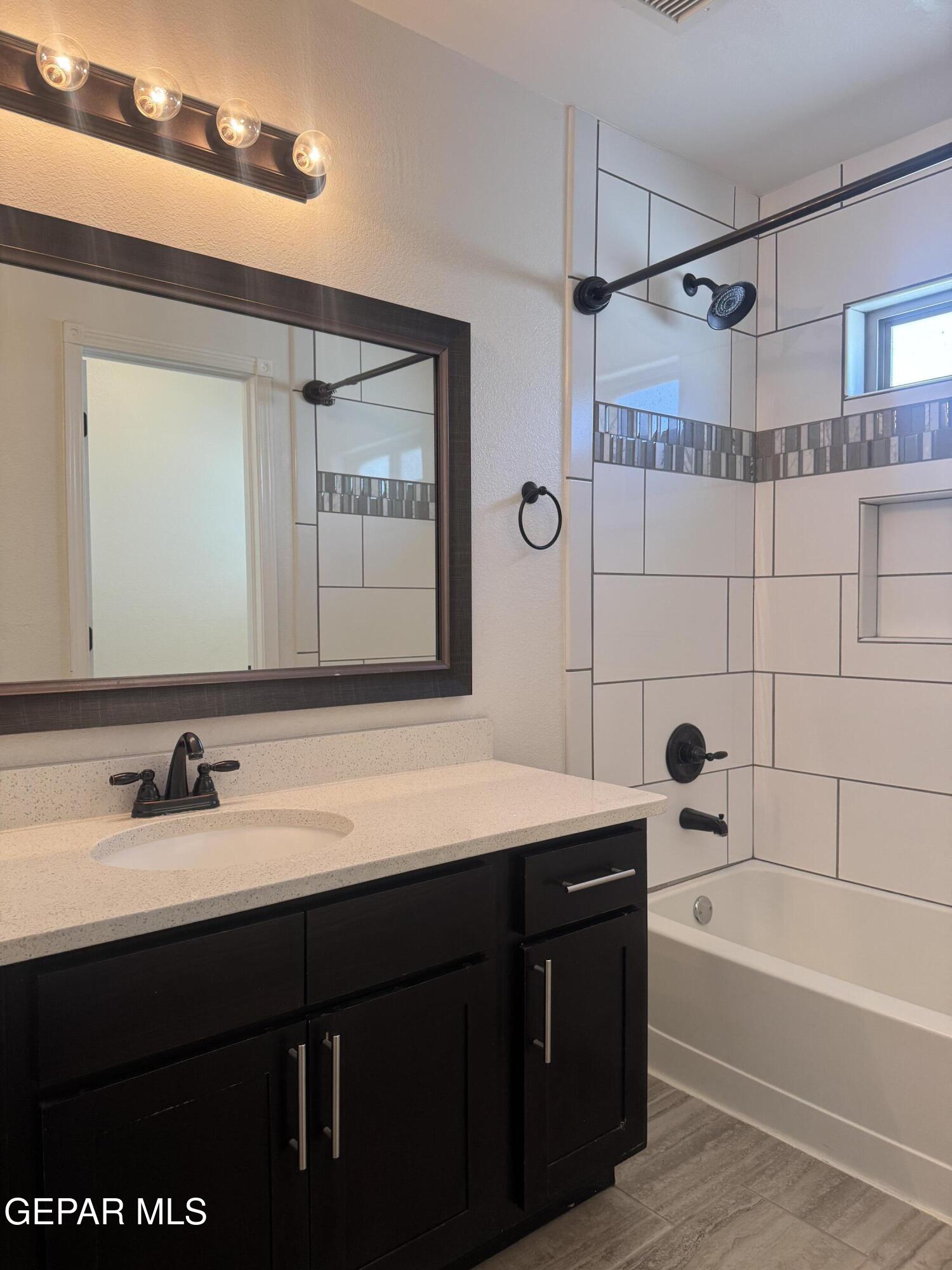 412 Indigo Court El Paso, TX 79932 - Photo 40 of 53 a bathroom with a tub sink and mirror