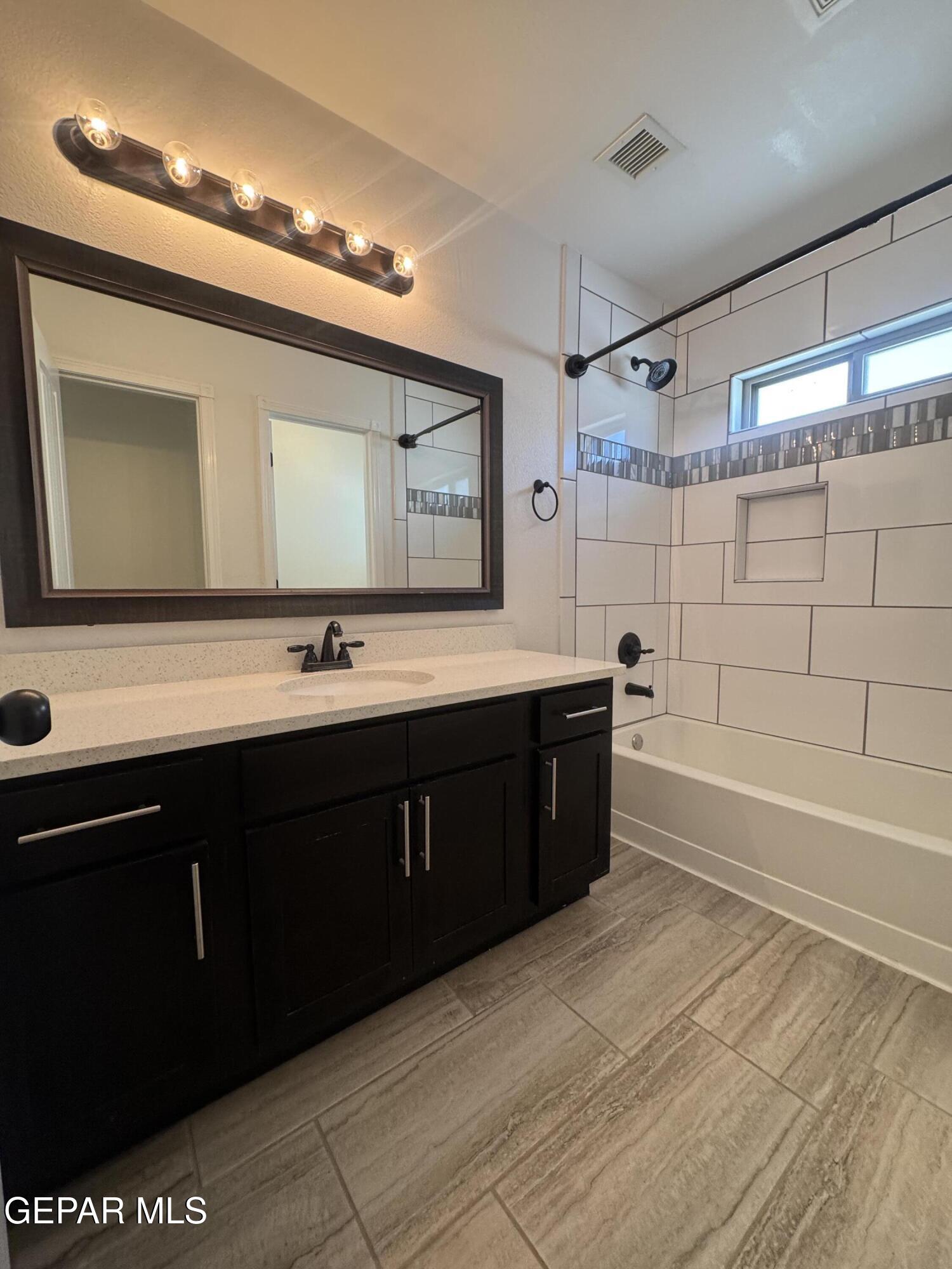 412 Indigo Court El Paso, TX 79932 - Photo 41 of 53 a spacious bathroom with a double vanity sink a mirror and a bathtub