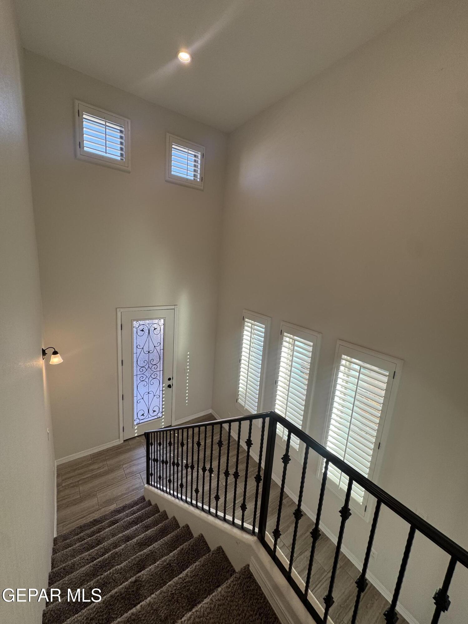 412 Indigo Court El Paso, TX 79932 - Photo 7 of 53 a view of staircase with lots of frames on wall and a window