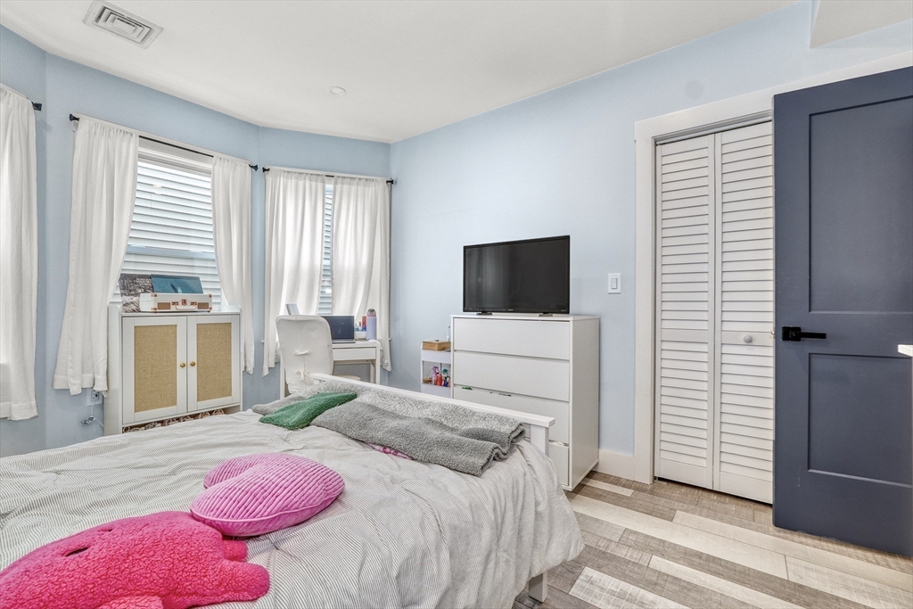 61 Shepton Street Boston, MA 02124 - Photo 11 of 38 a bedroom with a bed and large windows