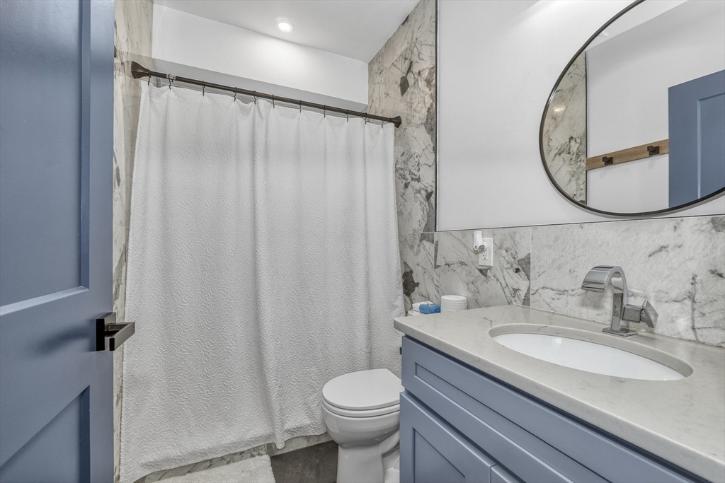 61 Shepton Street Boston, MA 02124 - Photo 13 of 38 a bathroom with a granite countertop sink toilet and a mirror
