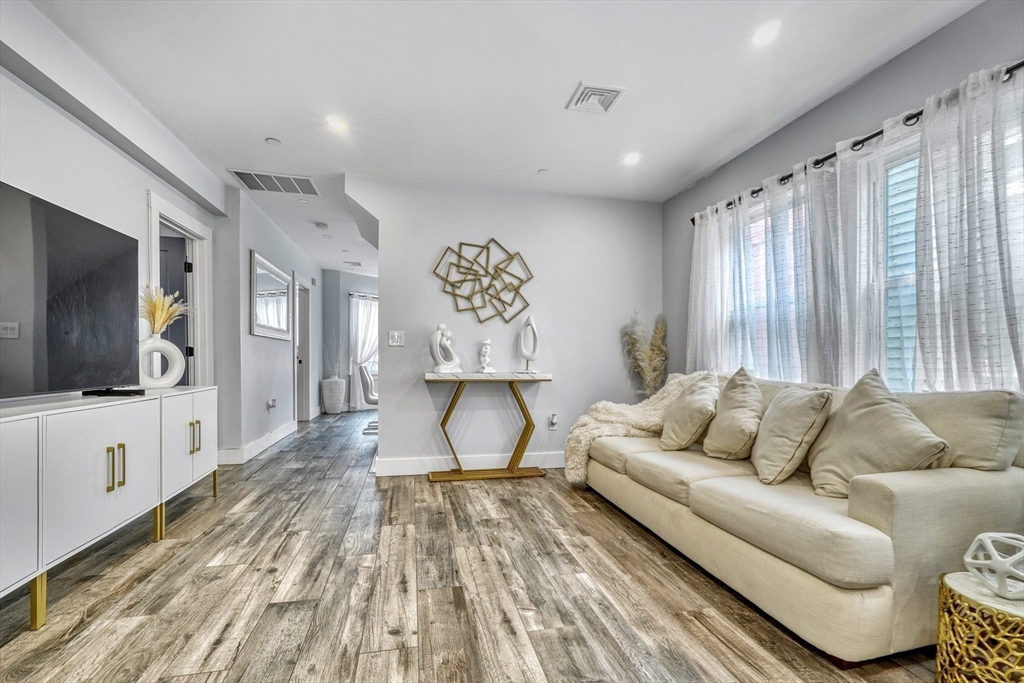 61 Shepton Street Boston, MA 02124 - Photo 14 of 38 a living room with furniture and a flat screen tv