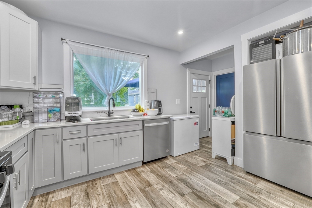 61 Shepton Street Boston, MA 02124 - Photo 17 of 38 a kitchen with a refrigerator sink and cabinets