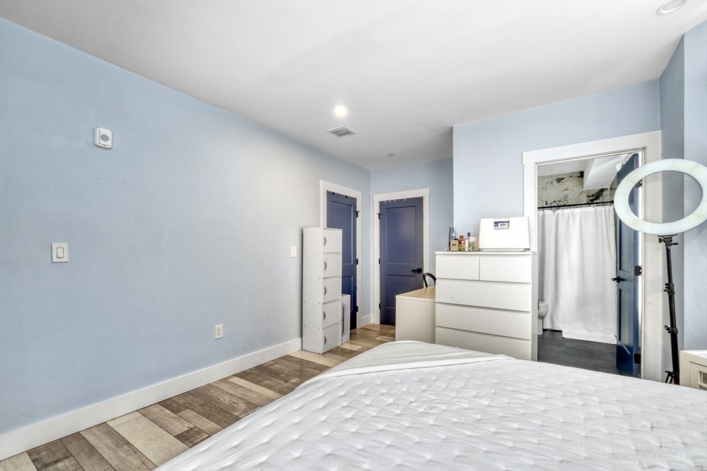 61 Shepton Street Boston, MA 02124 - Photo 21 of 38 a room with a bed and cabinets