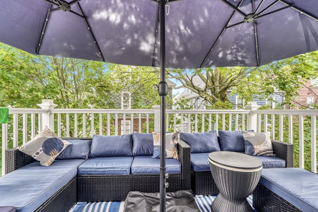 61 Shepton Street Boston, MA 02124 - Photo 29 of 38 a balcony with a couch and an umbrella