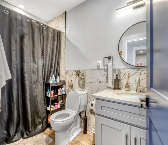 a bathroom with a sink toilet and shower