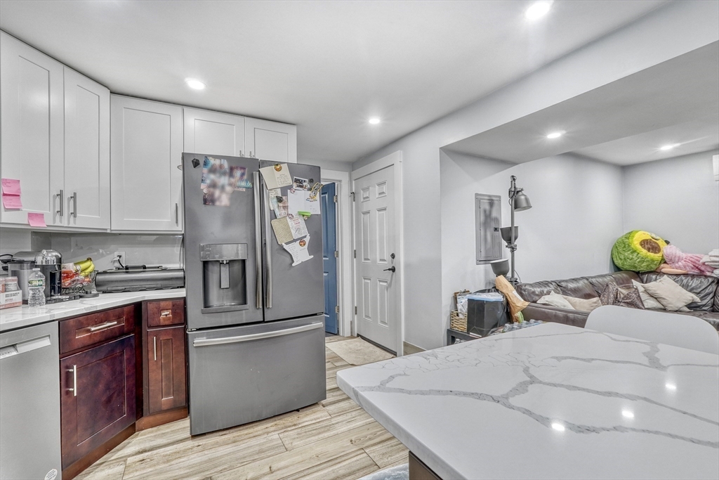 61 Shepton Street Boston, MA 02124 - Photo 32 of 38 a kitchen with stainless steel appliances granite countertop a refrigerator and a sink