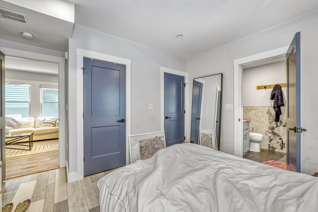 61 Shepton Street Boston, MA 02124 - Photo 7 of 38 a bedroom with a bed and a large mirror