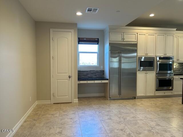 5200 Breakers Way Oxnard, CA 93035 - Photo 12 of 75 a kitchen with granite countertop a refrigerator and a sink