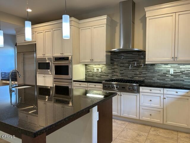 5200 Breakers Way Oxnard, CA 93035 - Photo 17 of 75 a kitchen with stainless steel appliances a stove a sink a microwave and cabinets