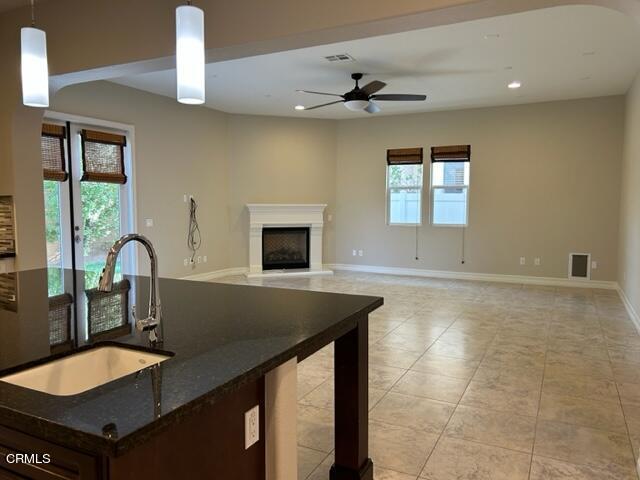5200 Breakers Way Oxnard, CA 93035 - Photo 19 of 75 a kitchen with kitchen island a sink appliances and a counter space