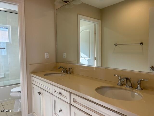 5200 Breakers Way Oxnard, CA 93035 - Photo 60 of 75 a bathroom with a granite countertop sink and a mirror