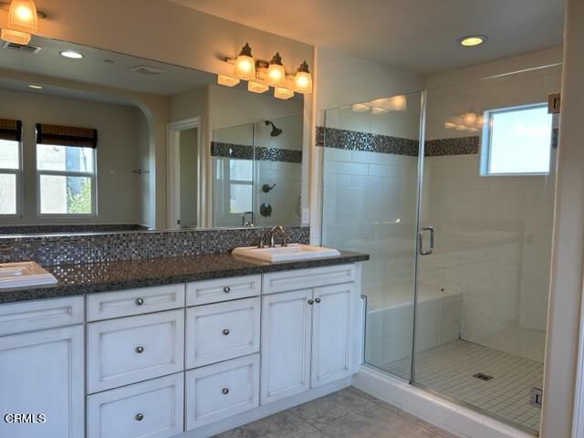 5200 Breakers Way Oxnard, CA 93035 - Photo 75 of 75 a bathroom with a granite countertop sink a mirror and a shower
