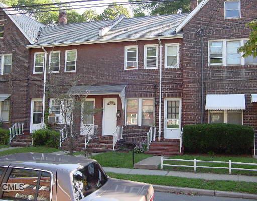 57 Alanson Road, Unit 57 Bridgeport, CT 06607 - Photo 1 of 1 a front view of a house with a yard and outdoor seating