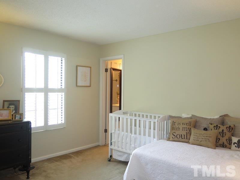 7752 Falcon Rest Circle, Unit 7752 Raleigh, NC 27615 - Photo 14 of 17 a bedroom with a bed and a window