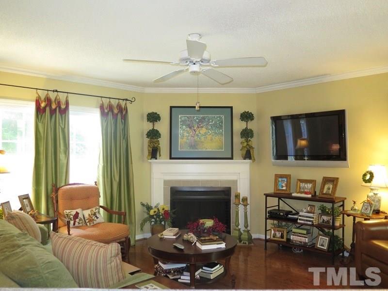 7752 Falcon Rest Circle, Unit 7752 Raleigh, NC 27615 - Photo 3 of 17 a living room with furniture a flat screen tv and a fireplace