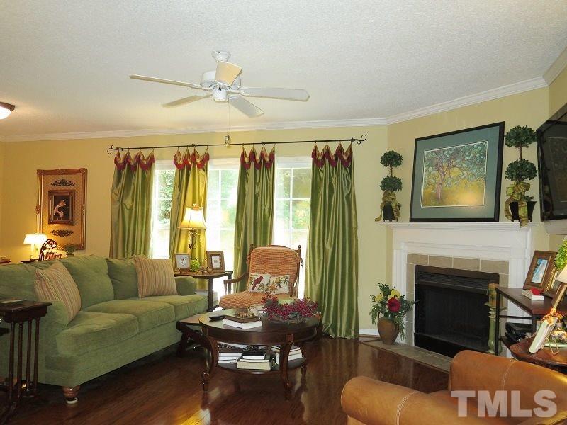 7752 Falcon Rest Circle, Unit 7752 Raleigh, NC 27615 - Photo 4 of 17 a living room with furniture fireplace and a flat screen tv