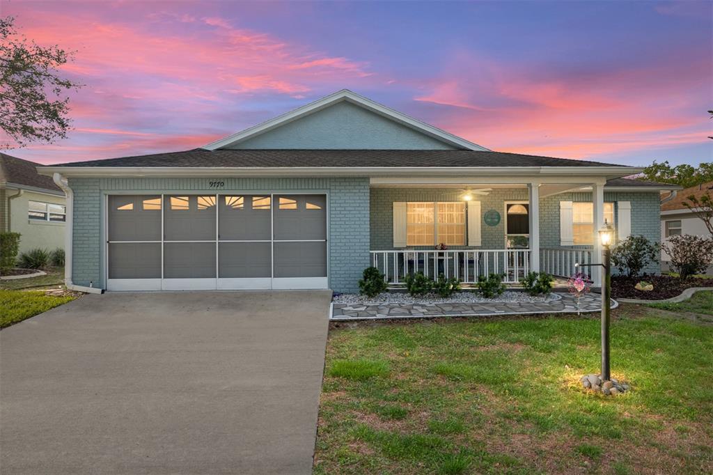 a front view of a house with a yard and porch