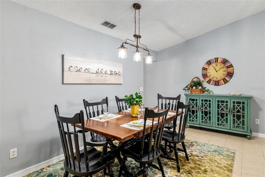 9770 Southwest 97th Place Ocala, FL 34481 - Photo 14 of 64 a view of a dining room with furniture and wooden floor