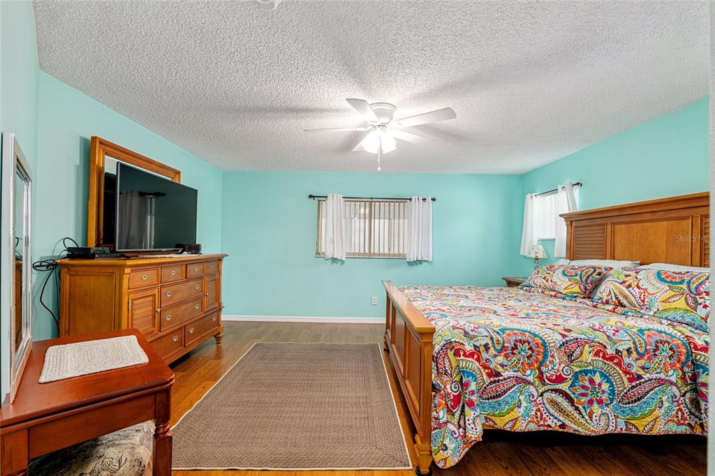 9770 Southwest 97th Place Ocala, FL 34481 - Photo 26 of 64 a bedroom with a bed and a flat screen television