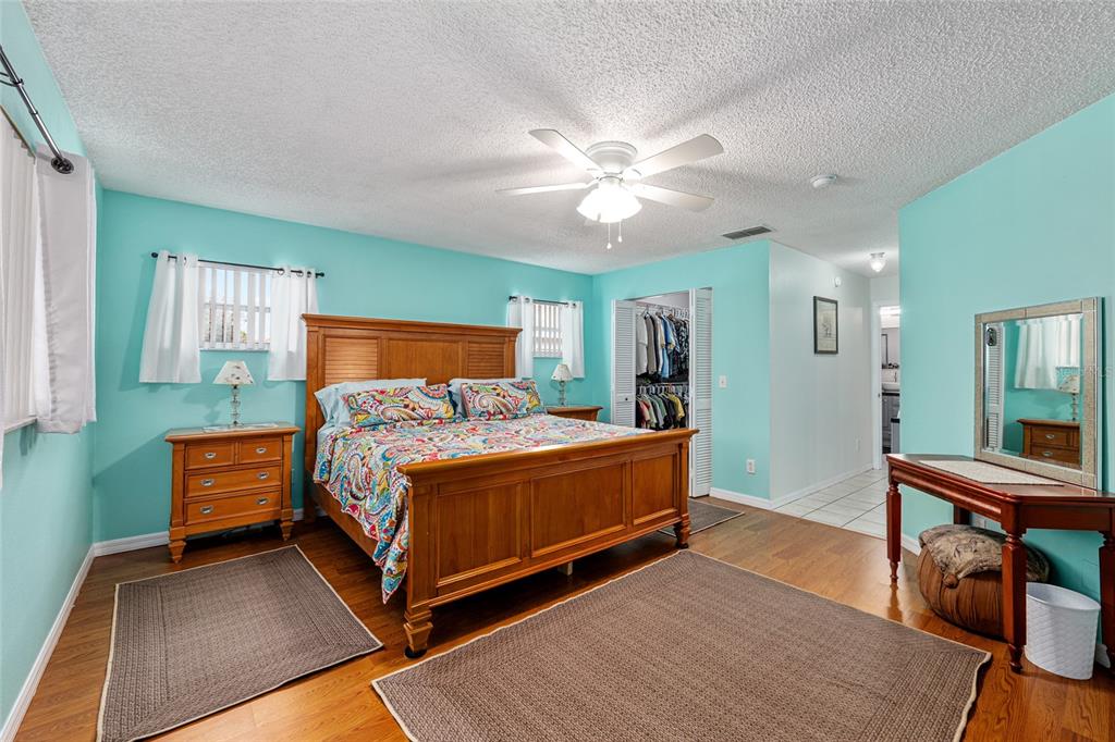 9770 Southwest 97th Place Ocala, FL 34481 - Photo 27 of 64 a bed room with a bed and a chandelier