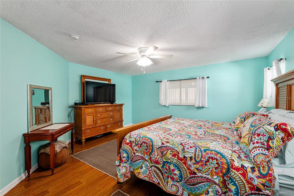 9770 Southwest 97th Place Ocala, FL 34481 - Photo 28 of 64 a bedroom with a bed and a tv on table