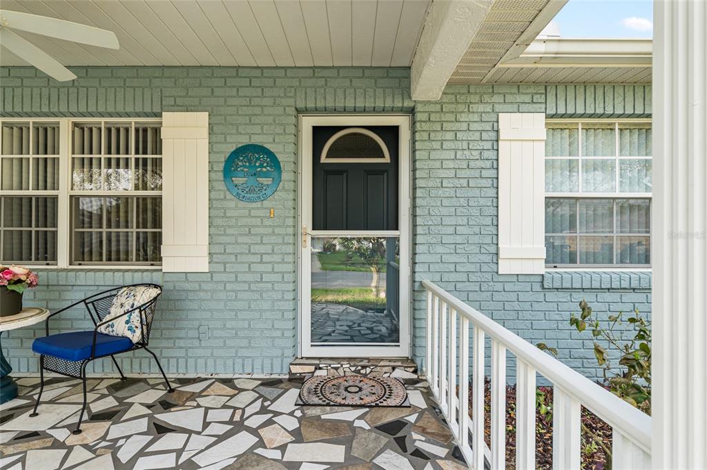 9770 Southwest 97th Place Ocala, FL 34481 - Photo 3 of 64 a front view of a house with outdoor seating
