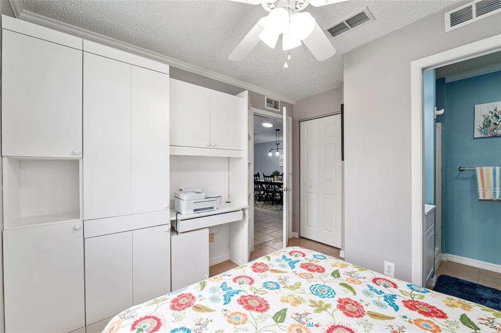 9770 Southwest 97th Place Ocala, FL 34481 - Photo 36 of 64 a bedroom with a bed and a chandelier