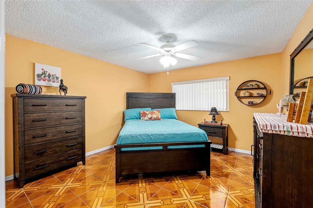 9770 Southwest 97th Place Ocala, FL 34481 - Photo 39 of 64 a bedroom with a bed and a chandelier