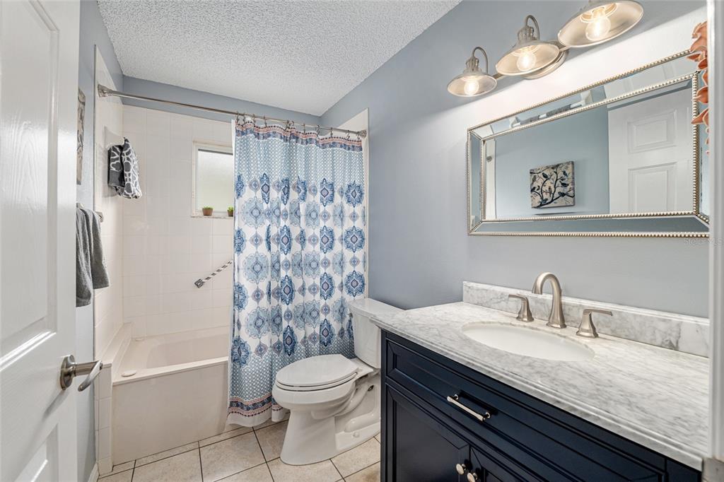 9770 Southwest 97th Place Ocala, FL 34481 - Photo 42 of 64 a bathroom with a granite countertop sink toilet a shower and a mirror