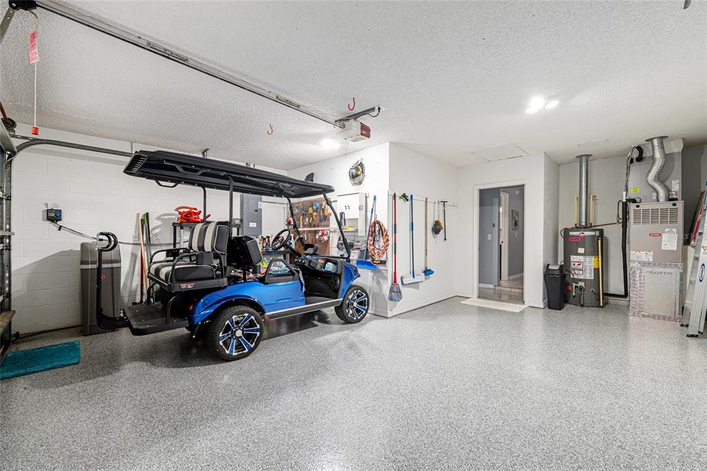 9770 Southwest 97th Place Ocala, FL 34481 - Photo 46 of 64 a view of a garage with a bike and car